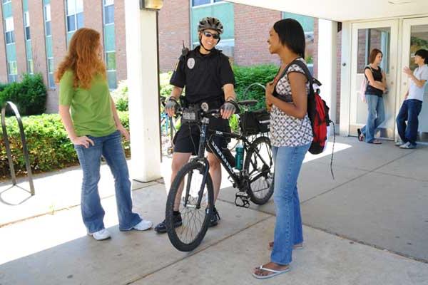 Students with patrol on a bike.